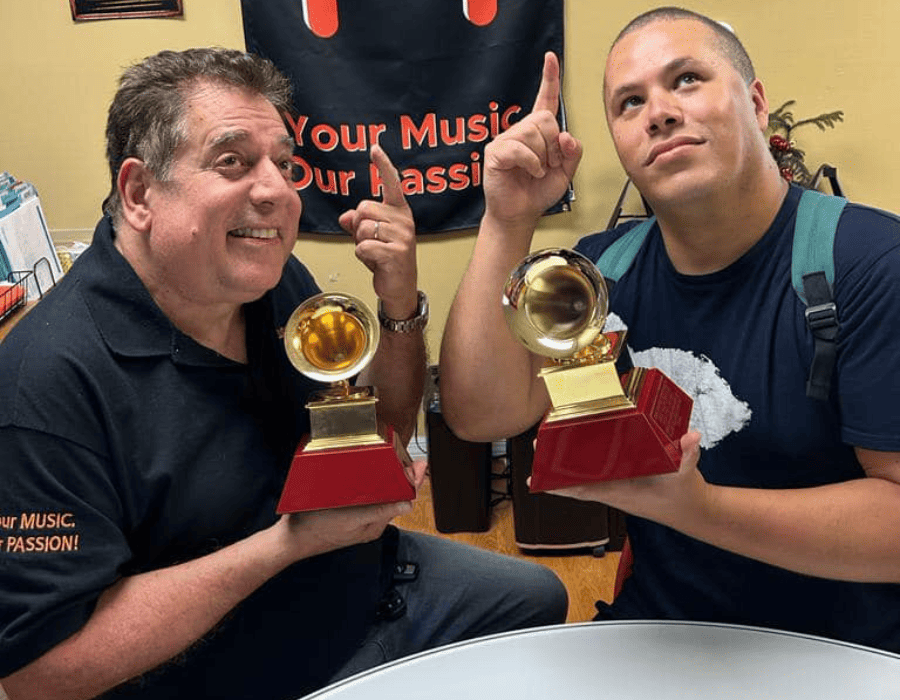 Lannie and Jose holding Grammys